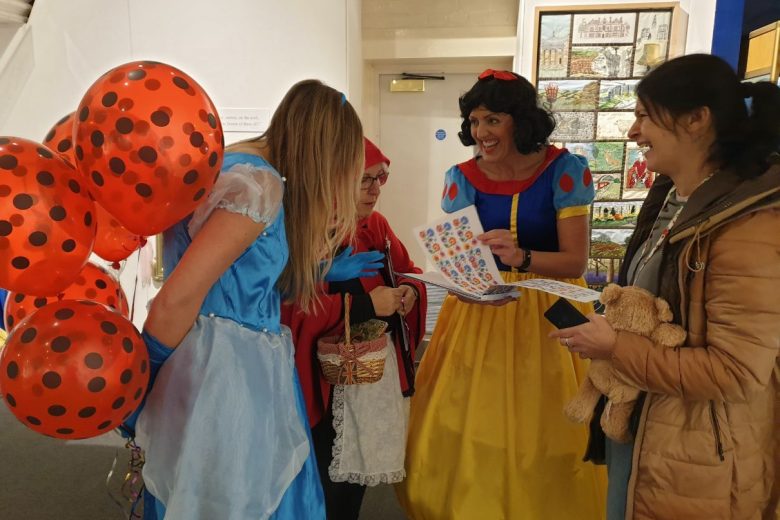 Participation workers dressed up as Cinderella, Snow White and Little Red Riding Hood