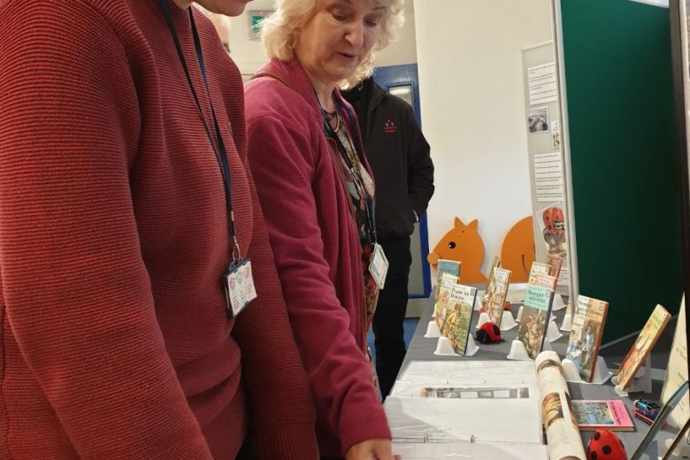 Two people looking at an exhibition table