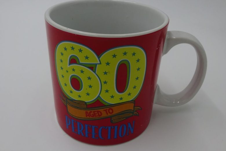 Red mug with the words: 60. aged to perfection.