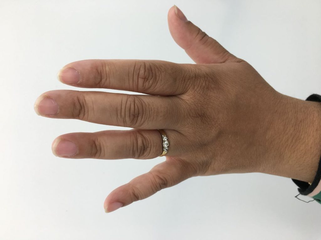 Yasmin's hand with a ring on her wedding finger