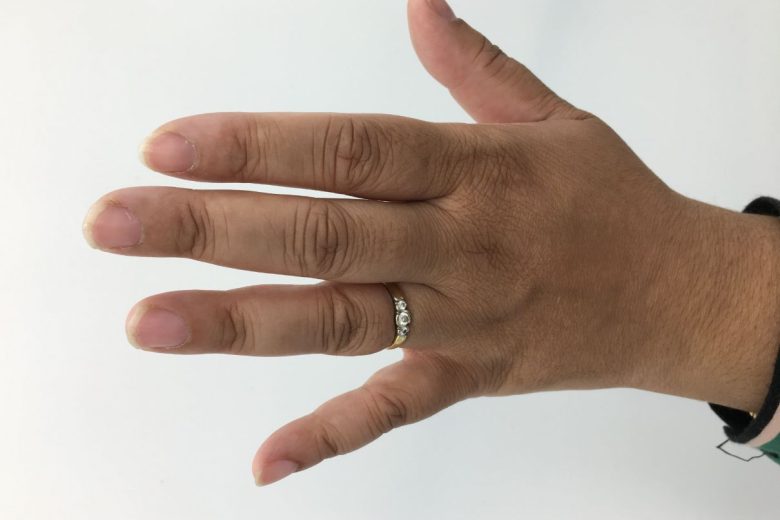 Yasmin's hand with a ring on her wedding finger