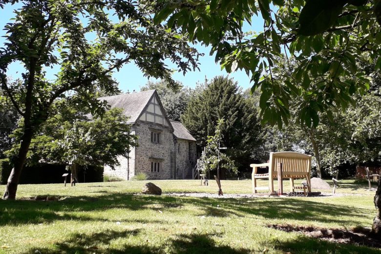 View of the garden, with the house partially obscured in the background.