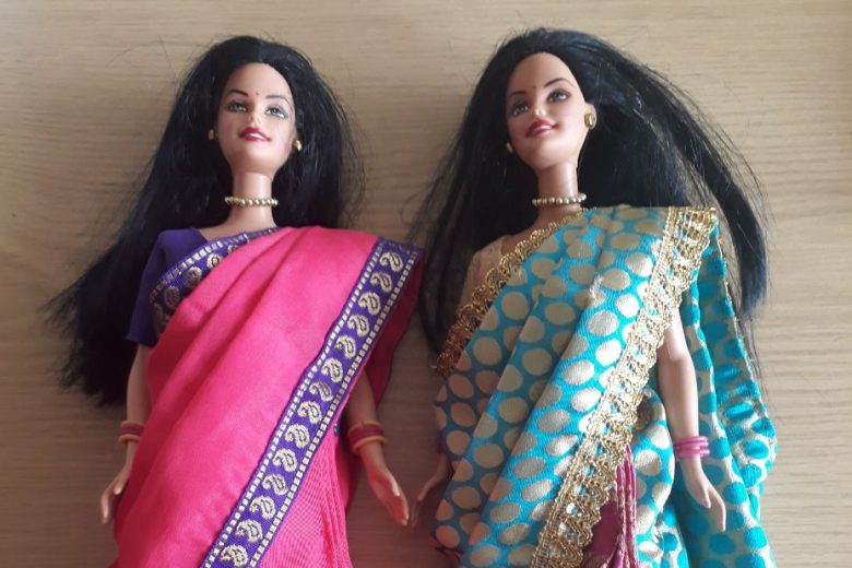 Two barbie dolls wearing saris