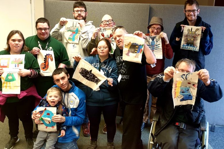 Adult learning group members holding up their 3D pictures of what sailors might have seen