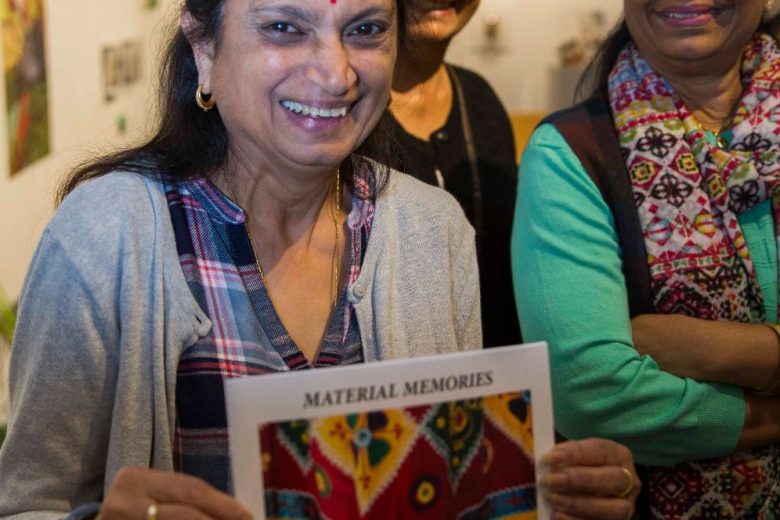 Anand Mangal lady smiling and holding up a piece of paper featuring colourful pattern titled Material Memories