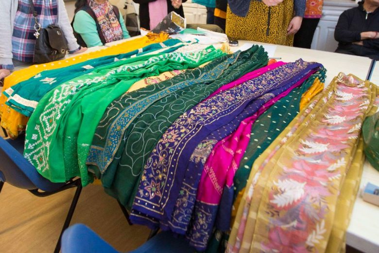 Table with various colourful fabrics on it