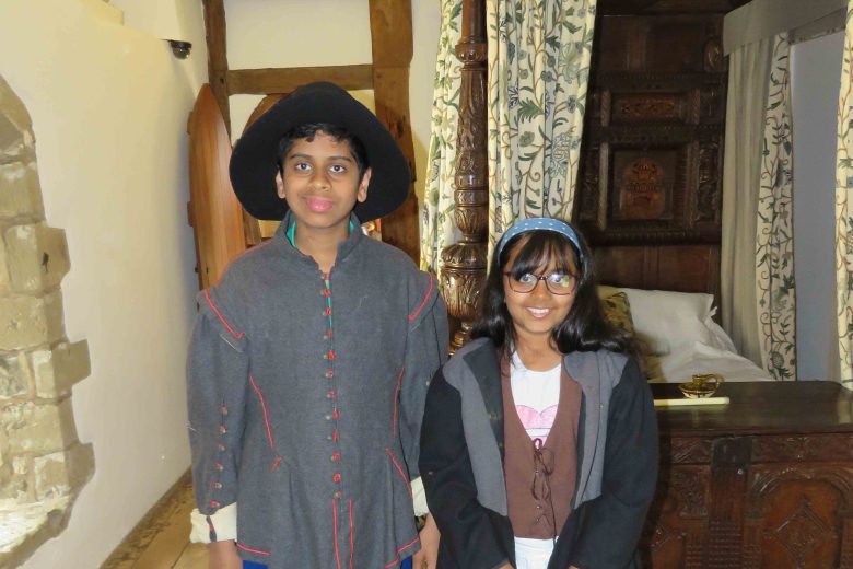 A young boy and girl dressed up in 1600s garments