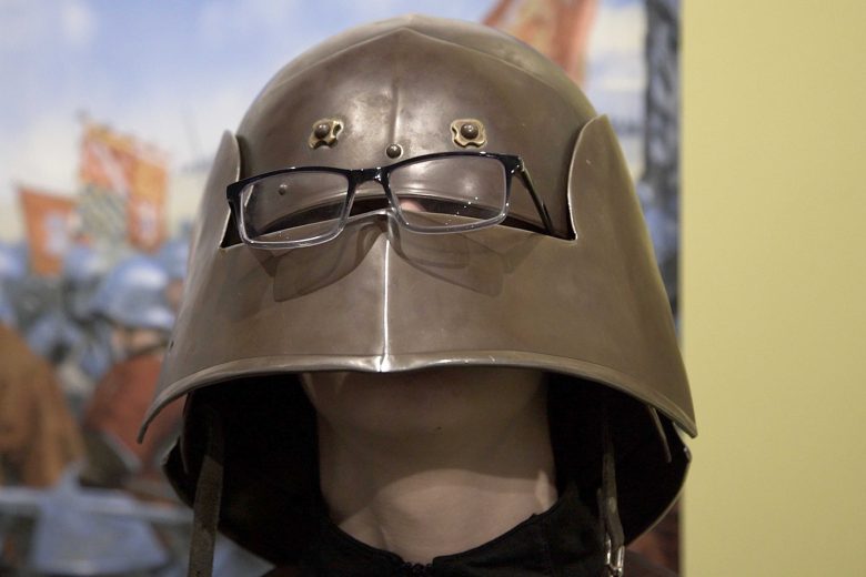 A knight's helmet with modern glasses on