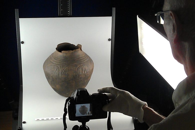 Man photographing an urn