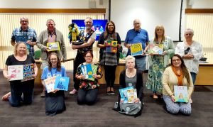 Foster carers holding up children's books