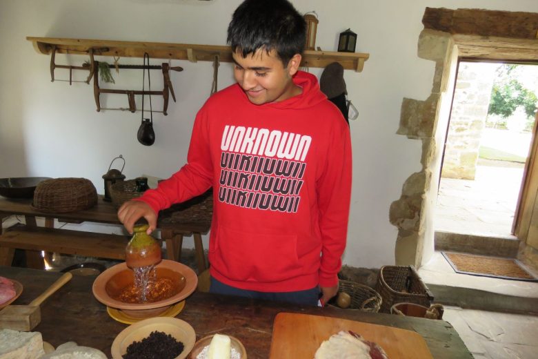 Young boy using kitchen utensils