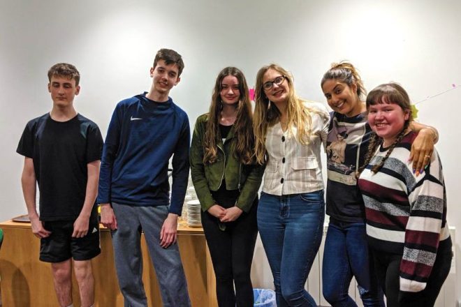 A group of young people smiling for the camera