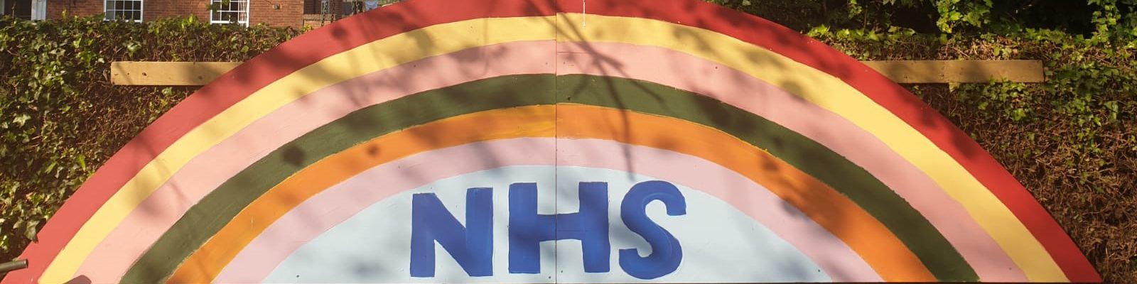 hand painted rainbow with NHS logo underneath