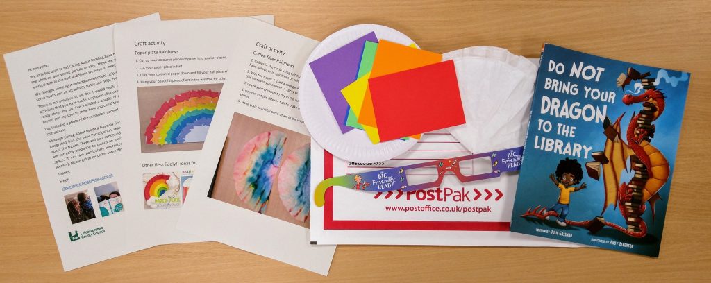 Craft package with instructions, coloured pieces of card, 3D glasses and a book called do not bring your dragon to the library