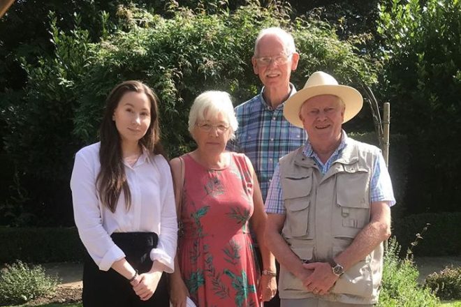 Two men and two women stood outside in the garden