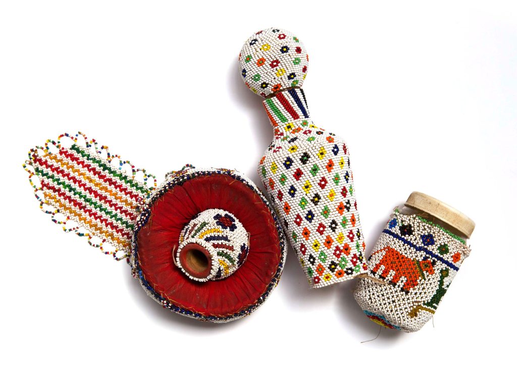 Various small objects with colourful beaded covering