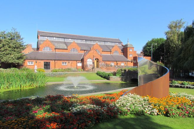 View of charnwood museum with the gardens and water fountain in front