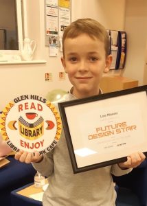 Leo holding up a framed award for future design star and his glen hills library and park cafe logo