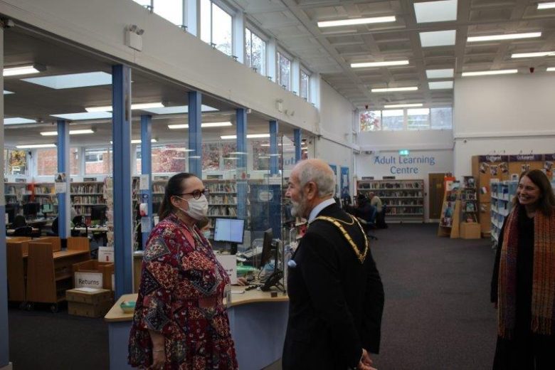 Chairman speaking to library supervisor christina inside the library