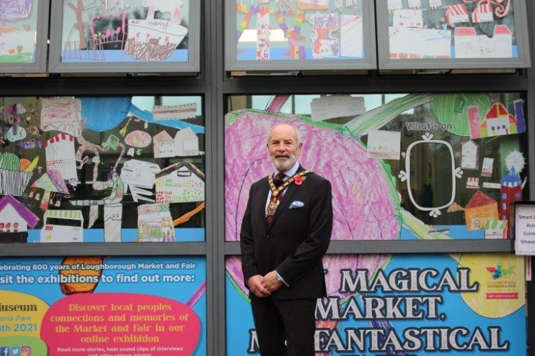 Chairman stood in front of the library window art display