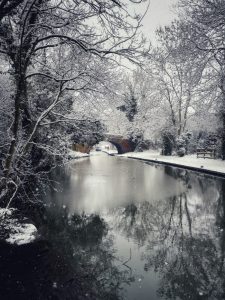 photograph of a snowy canal and path.