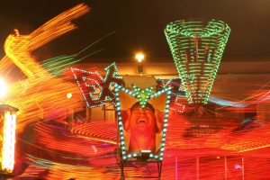 Fairground ride at night. Lights are blurry for effect.
