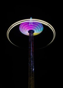 Fairground ride at night. Lights are blurry for effect.