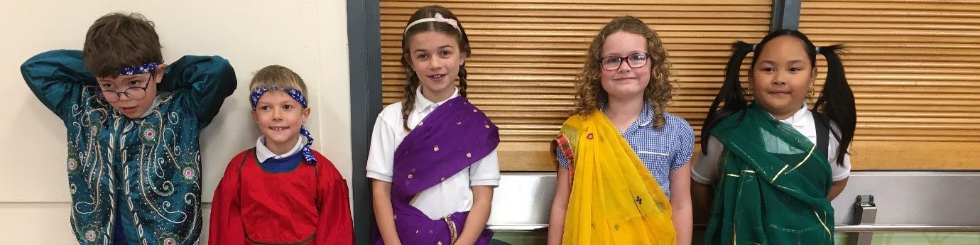 Group of school children wearing saris over their uniforms