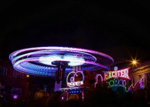 Fairground ride at night. Lights are blurry for effect.