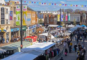 View from above of the market featuring stalls and bunting.