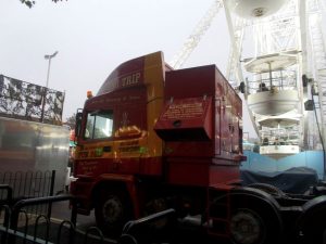 Fairground truck. Ferris wheel has been assembled in the background.