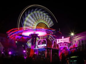 Fairground ride at night. Lights are blurry for effect.