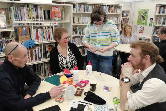 Group members sat around a craft table