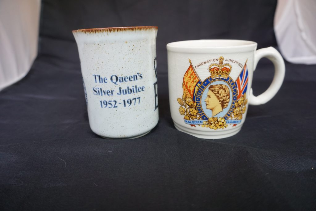 Back of the Silver Jubilee and coronation mugs